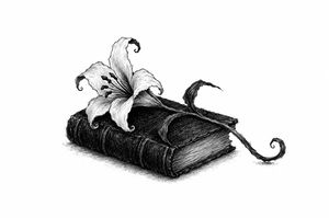 A small black book with a lily laid on it